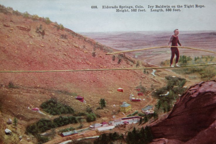 Man on High Wire walking Tightrope across a canyon