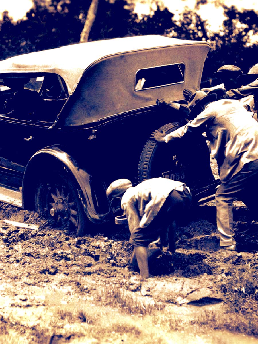 1920s Car Stuck in Mud with Men Pushing it Out