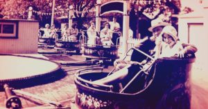 Early 1900s Amusement Park where a couple rides a bumper car