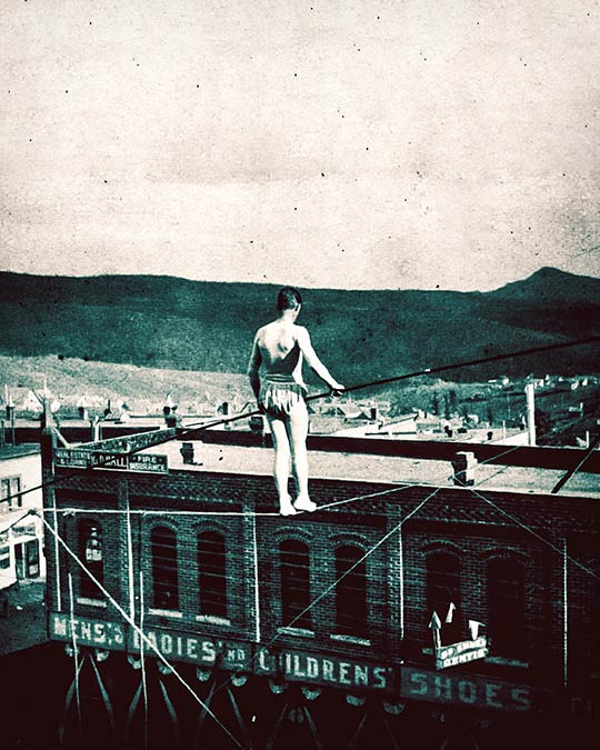 Man walking the high wire in western town