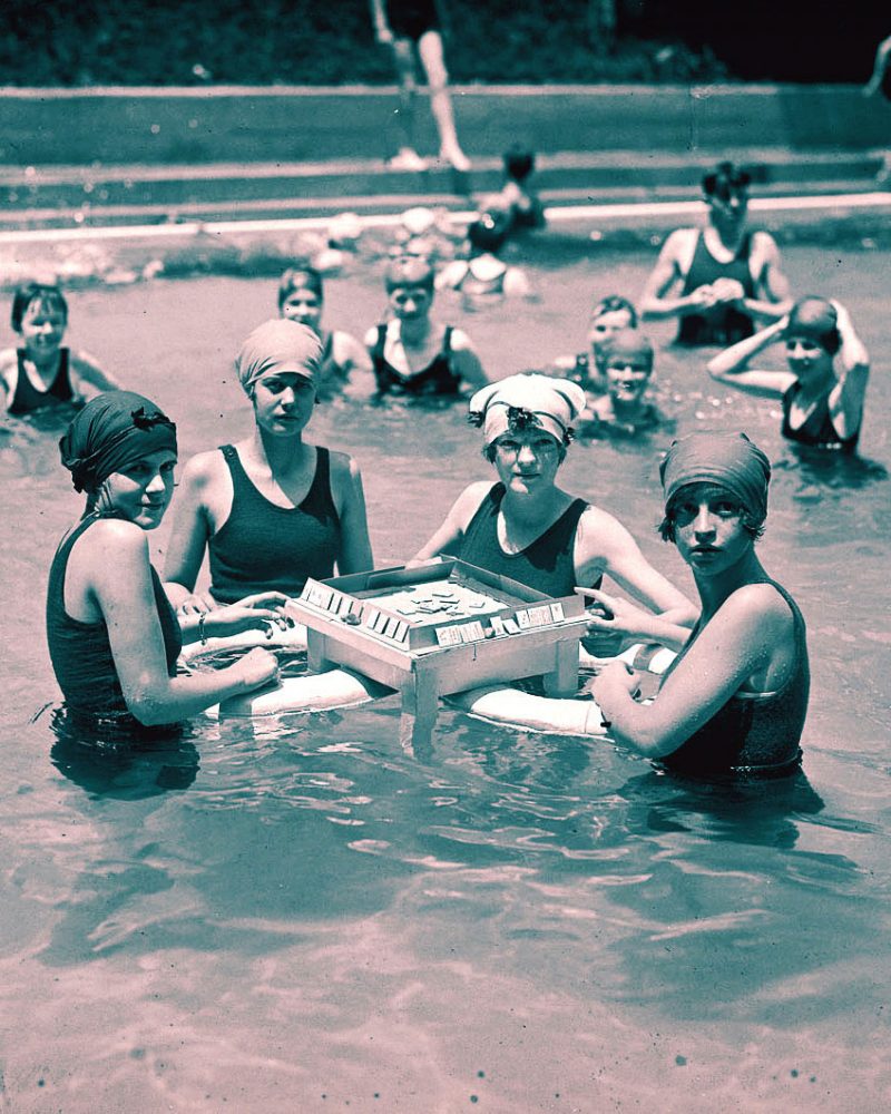 Women playing mahjong in pool