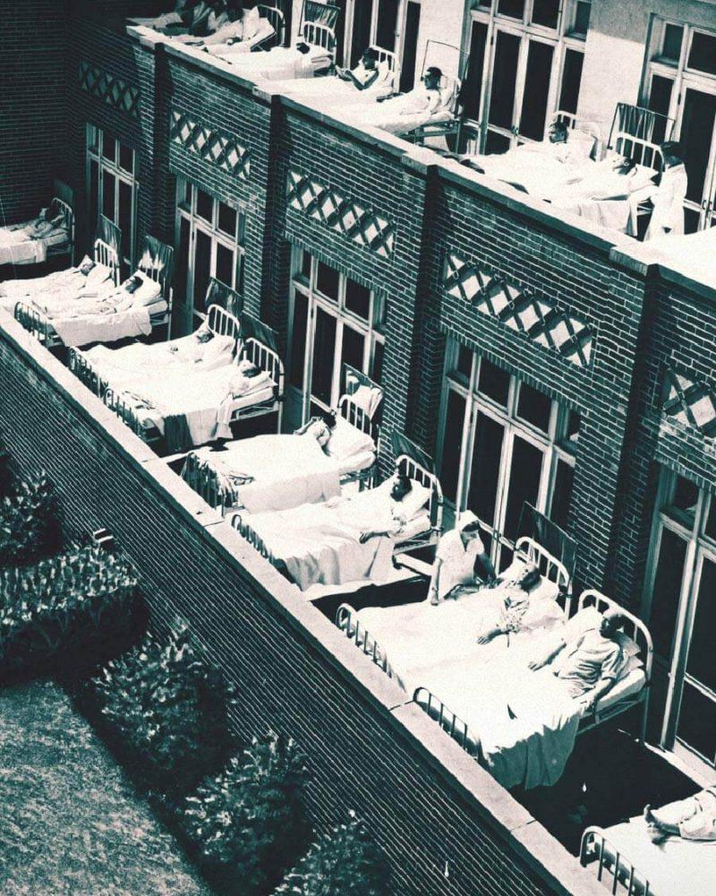 Patients in beds on balcony